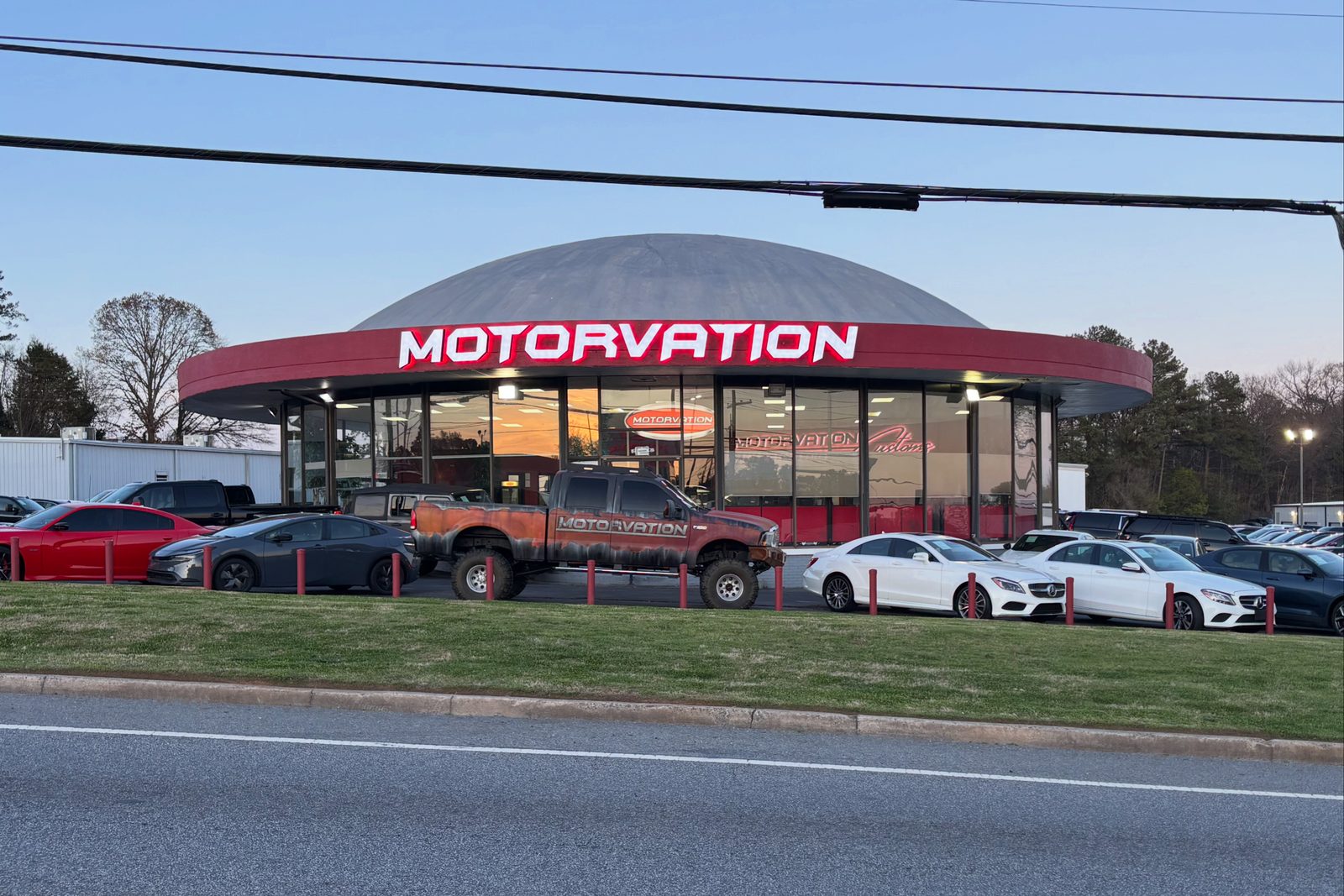 Motorvation dealership building with a lifted Motorvation-wrapped truck out front